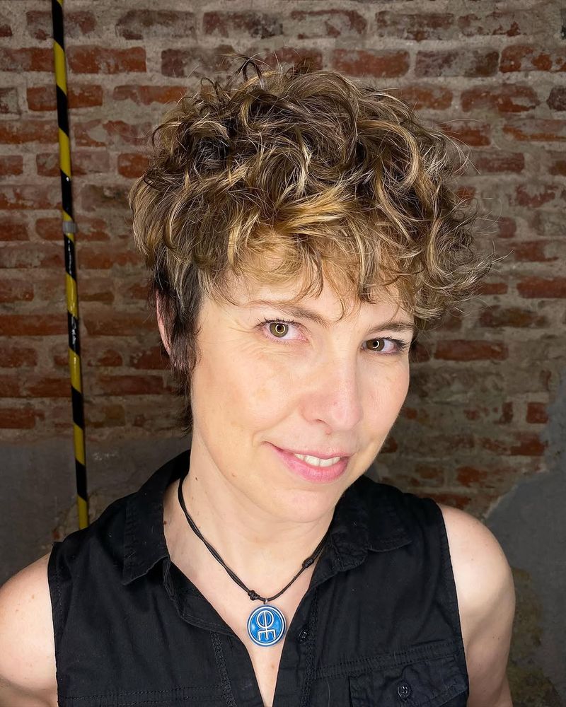 21. Curly Pixie with Playful Highlights