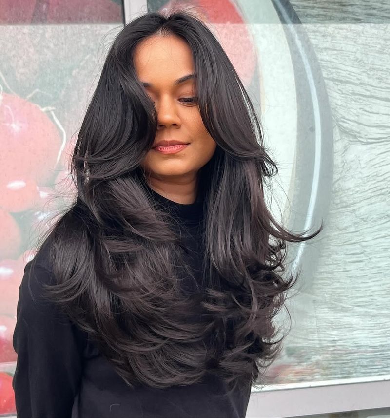 60. Dark Blowout Layers with Curtain Bangs