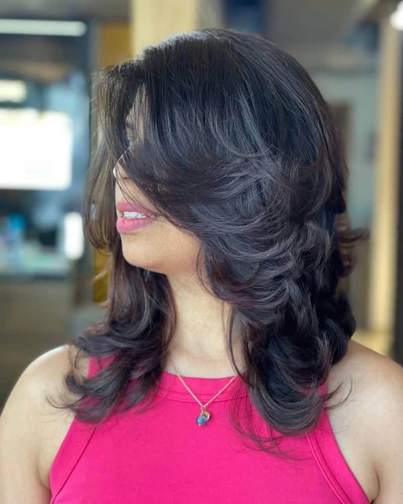 14. Feathered Retro Layers with Side-Swept Bangs