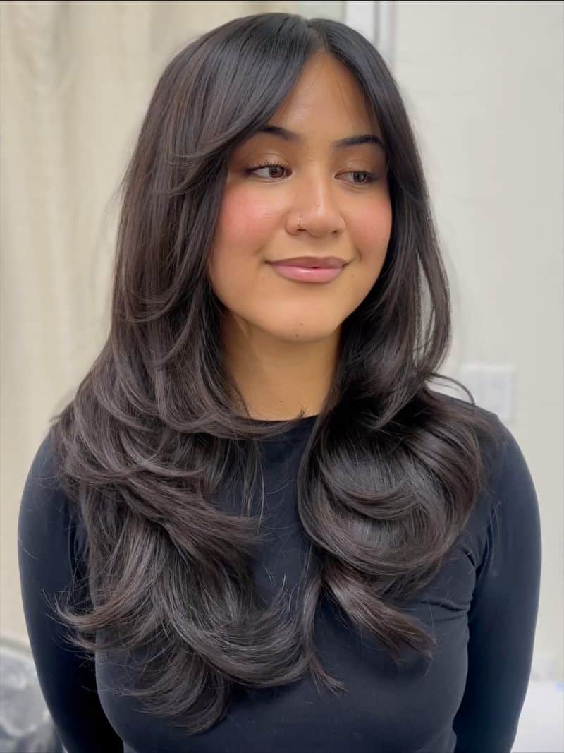 25. Soft Feathered Layers with Curtain Bangs