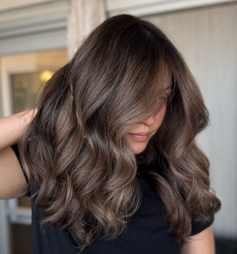 4. Soft Truffle Waves with Side-Swept Bangs