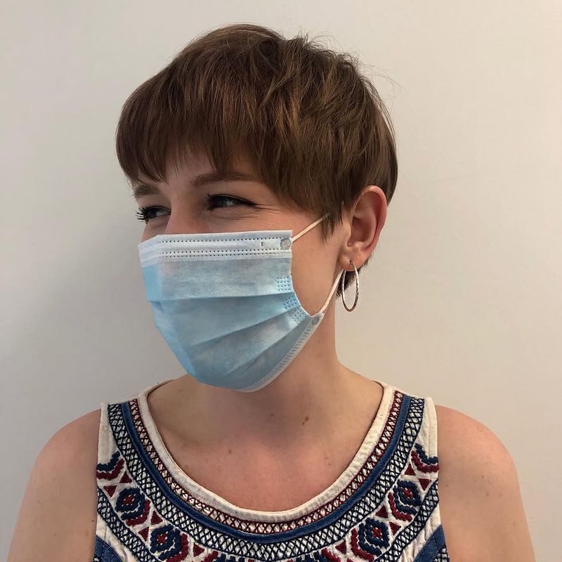 13. Textured Brown Pixie with Brow-Skimming Fringe