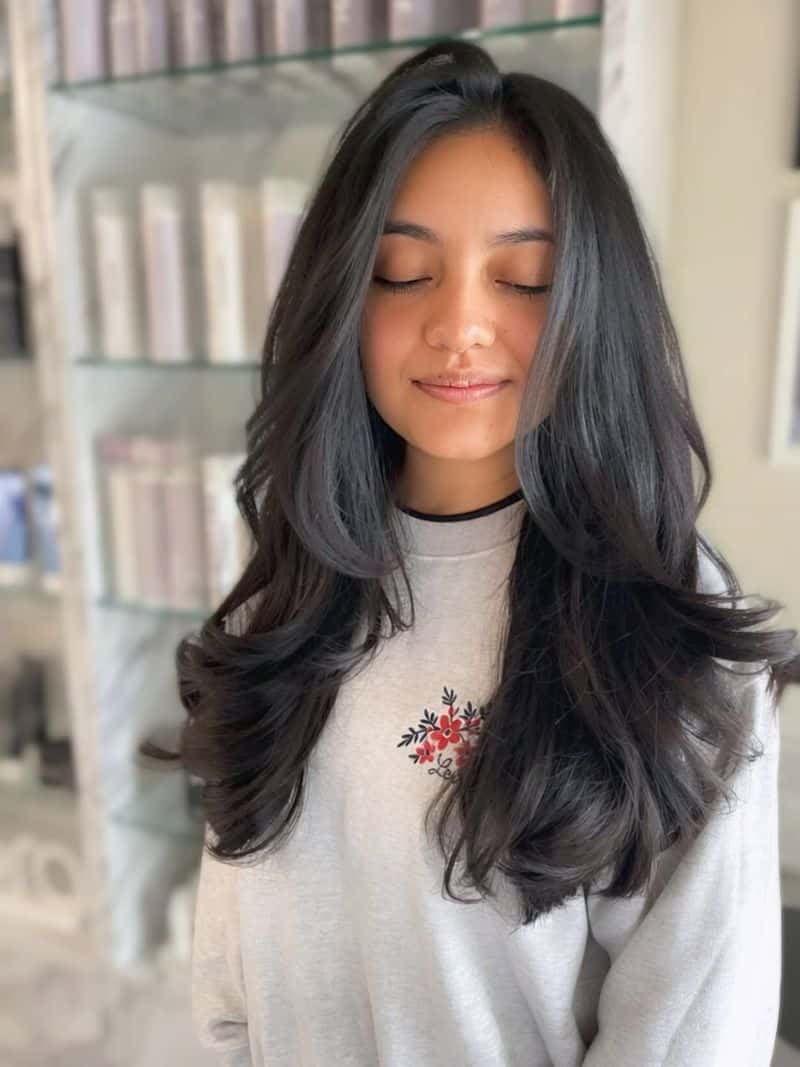 35. Velvet Jet-Black Blowout with Cascading Layers
